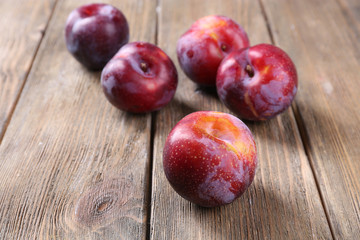 Sweet plums on wooden background