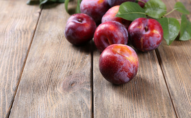 Sweet plums on wooden background