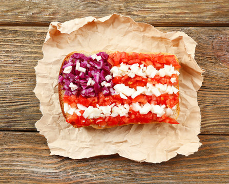 Sandwich with flag of USA on table close-up