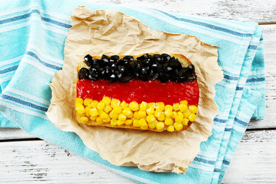 Sandwich with flag of Germany on table close-up