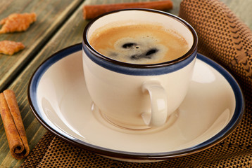 Coffee and cinnamon on a  wooden table