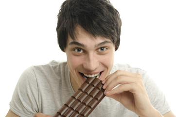 Happy man eating a yummy chocolate and having some sugar