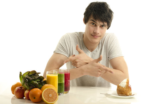Man choosing between fruits, smoothie, organic food and sweets
