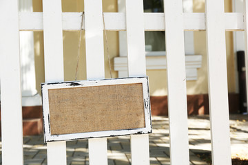 Fototapeta na wymiar Signboard hanging on wooden fence