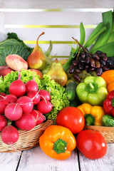 Vegetables in basket on white wooden box background