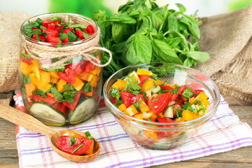 Vegetable salad in glass jar and bowl