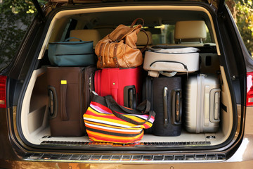 Suitcases and bags in trunk of car ready to depart for holidays