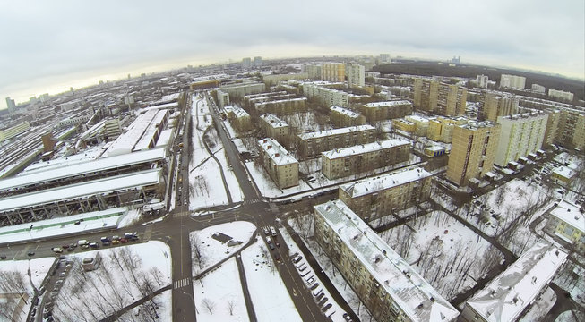Urban landscape with snow-covered streets on day, aerial view