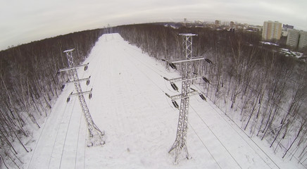 Big power line in the snowy forest near the city © Pavel Losevsky