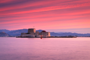 Sunset over Bourtzi castle in Nafplio, Greece.