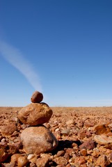 Stoneman in Australian stone desert on a background of blue blue sky