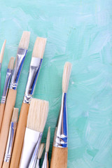 Paint brushes on blue background