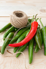 Red and green hot chili peppers on wooden boards