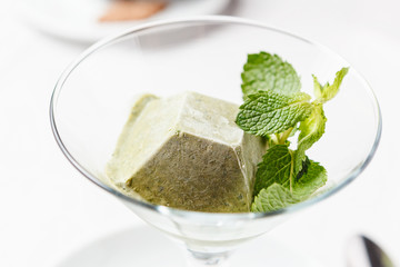 Basil ice cream with basil leaf.