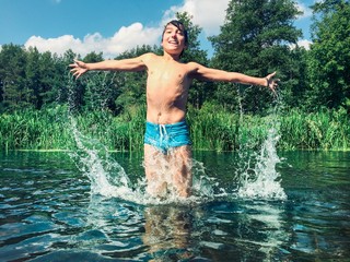 Young boy splashing in the water