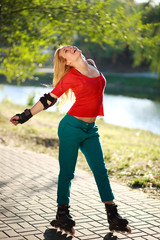 Happy young girl enjoying roller skating in park