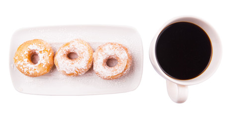 A mug of coffee and homemade doughnut with sugar toppings 