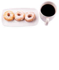 A mug of coffee and homemade doughnut with sugar toppings 