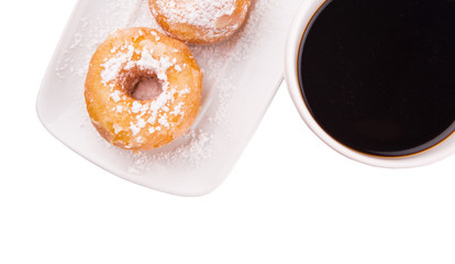 A mug of coffee and homemade doughnut with sugar toppings 