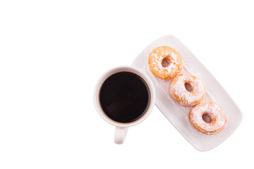 A mug of coffee and homemade doughnut with sugar toppings 