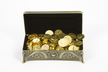 gold casket and gold coins on a white background 