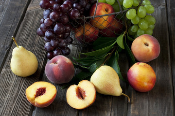 Juicy flavorful pears, grape, nectarines and peaches in basket