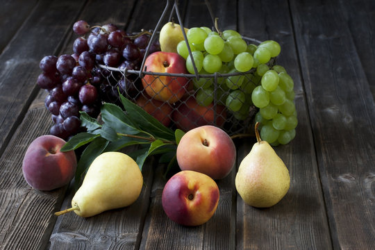 Basket with  nectarines, peaches, grape and pears