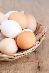 farm eggs in a basket on wooden table
