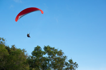 Paraglider in a blue sky