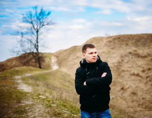 Young Handsome Man Stayed In Field, Meadow In Autumn Day