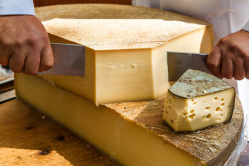 Man cutting piece of cheese