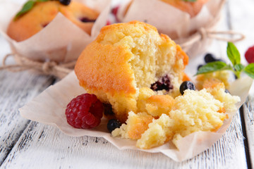 Tasty cupcakes with fruits on table close-up