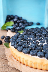 Tasty homemade pie with blueberries on wooden table