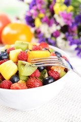 Delicious fruits salad in plate on table close-up