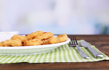 Chicken nuggets with sauce on table close-up