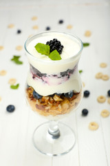 Natural yogurt with fresh berries on wooden table
