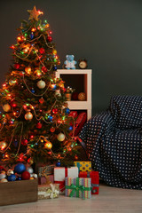 Decorated Christmas tree on home interior background at night