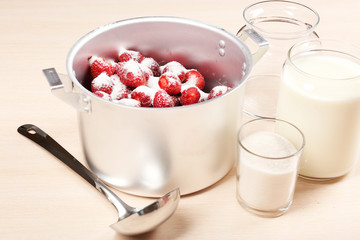 Cooking delicious strawberry jam in kitchen