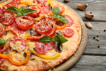 Delicious pizza served on wooden table