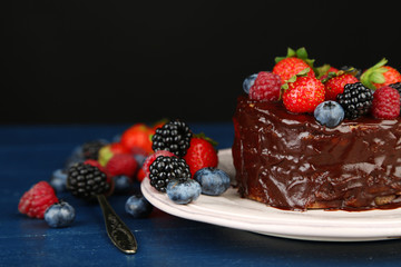 Tasty chocolate cake with different berries