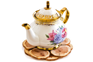 Ceramic teapot on Wooden stand .