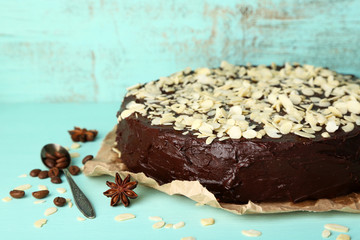 Tasty chocolate cake with almond, on old wooden table