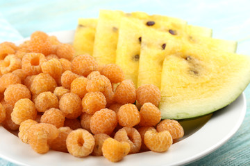 Slices of yellow watermelon and raspberry