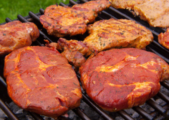 Fresh grilled steak on the grate. 