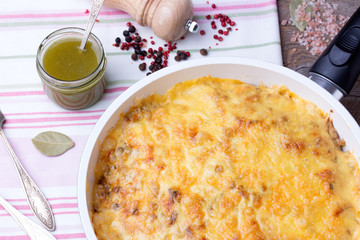 mushrooms and cabbage casserole in pan with pesto, pepper