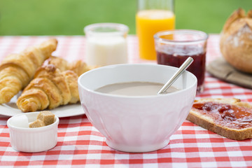 Breakfast with chocolate, orange juice, croissant, marmalade and
