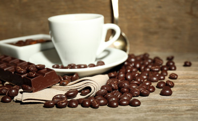 Cup of coffee and coffee beans with chocolate glaze