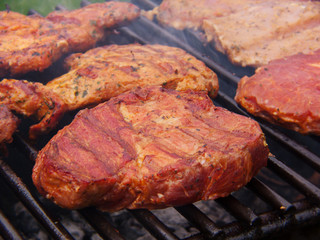 Fresh grilled steak on the grate. 