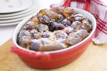 Traditional French Clafoutis with cherry in red plate