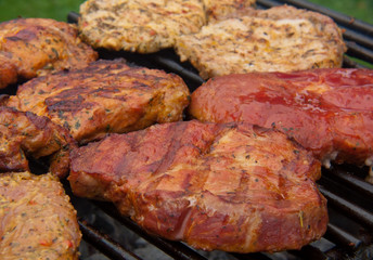 Fresh grilled steak on the grate. 